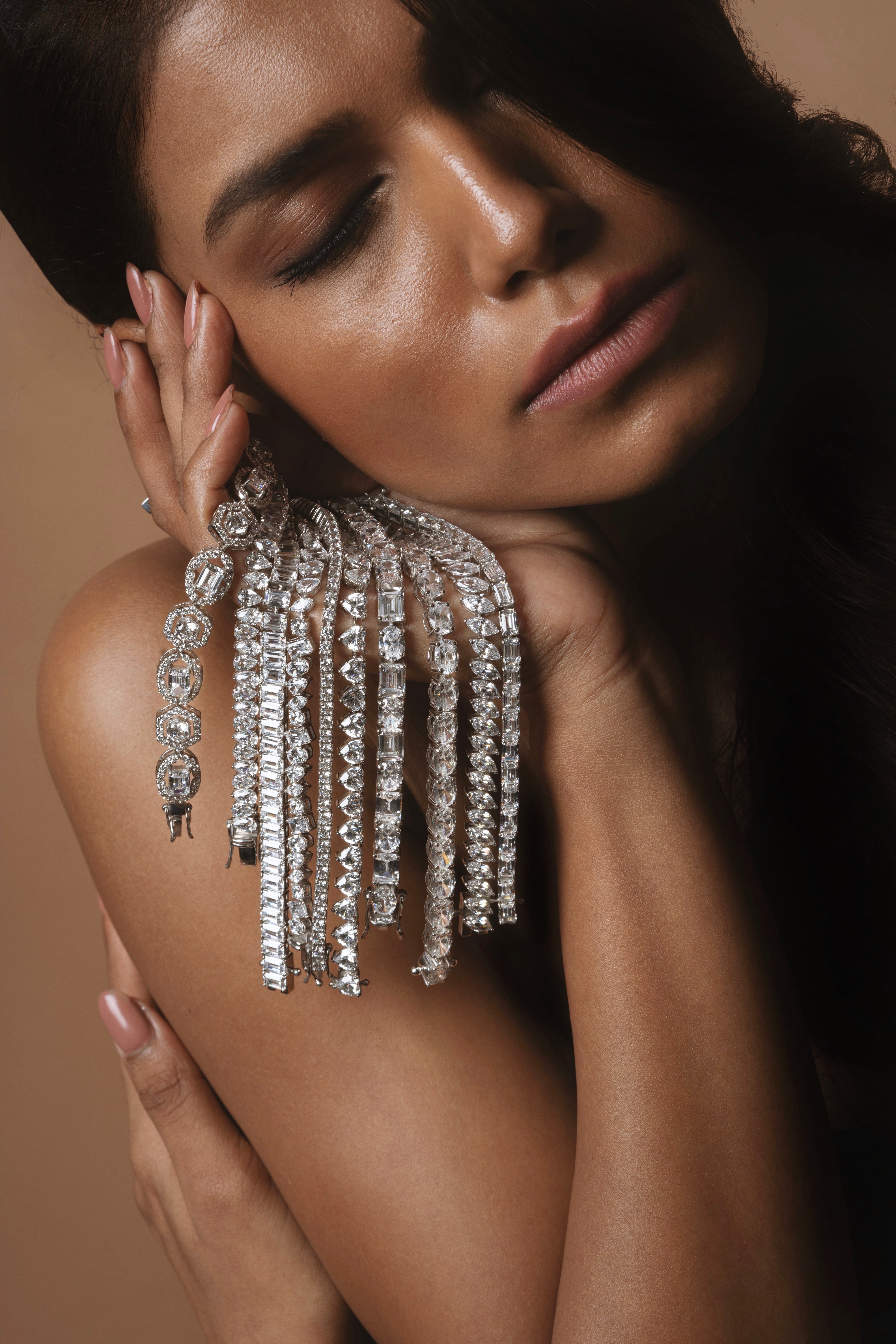 Layered silver tennis bracelets draped elegantly for styling inspiration
