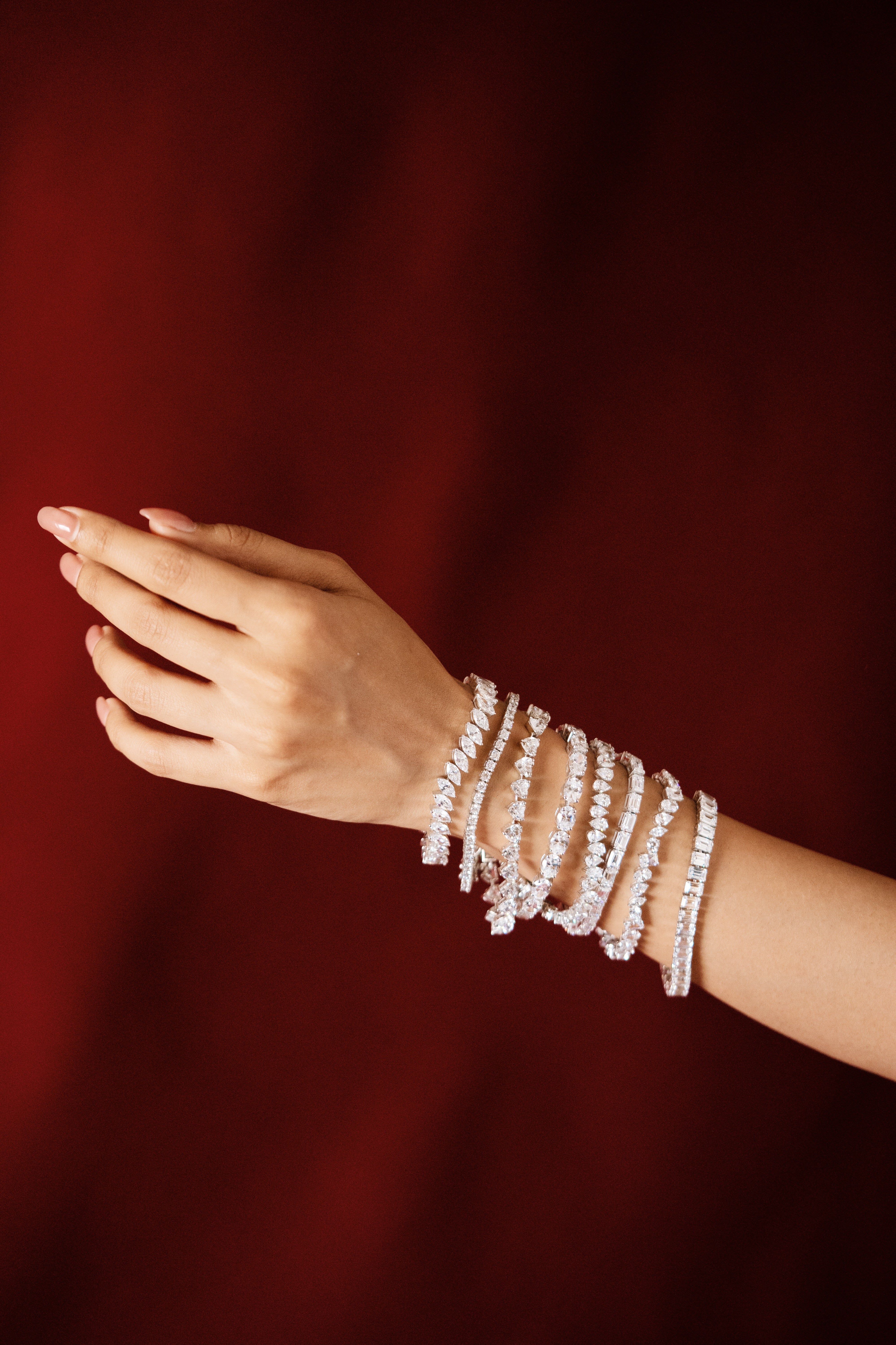 Silver tennis bracelet stack featuring pear, round and baguette-style stones